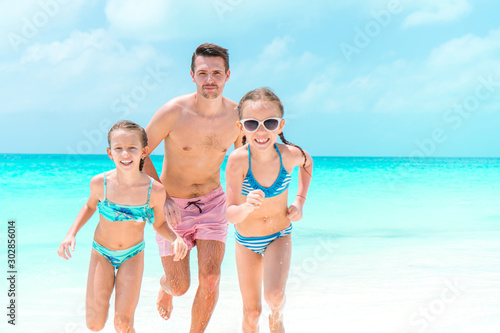 Father and kids enjoying beach summer vacation © travnikovstudio