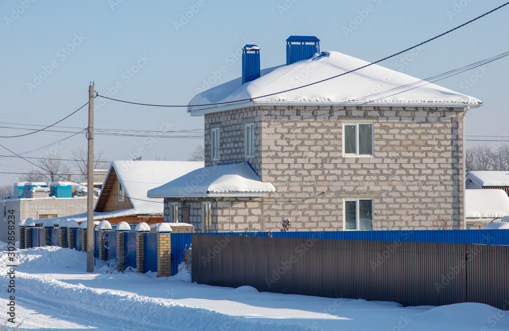 Brick house with snow on the roof Brick house with snow on the roof