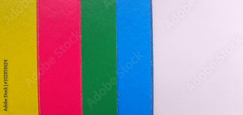 Children colored paper on a white background, located on the side, with space for text