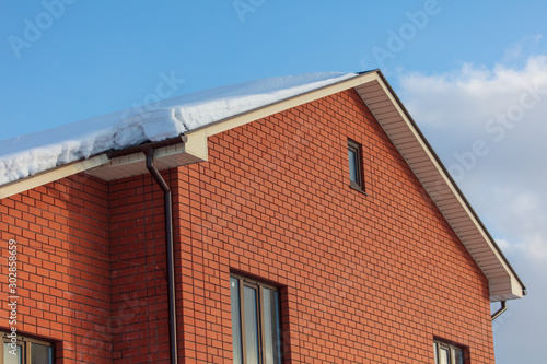 Brick house with snow on the roof