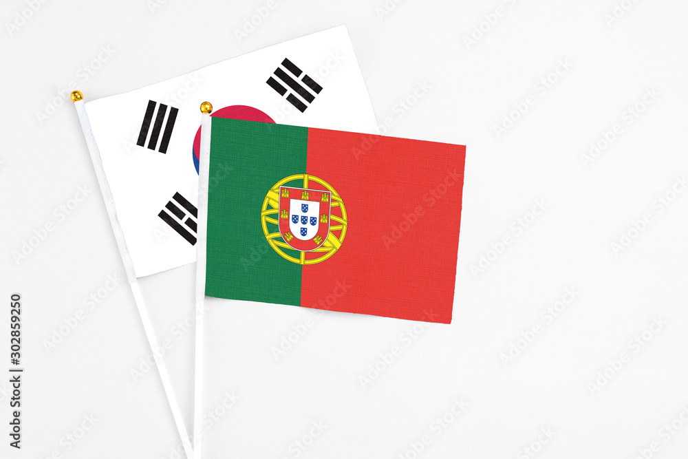 Portugal and South Korea stick flags on white background. High quality fabric, miniature national flag. Peaceful global concept.White floor for copy space. Portugal and South Korea stick flags on white background. High quality fabric, miniature national flag. Peaceful global concept.White floor for copy space.