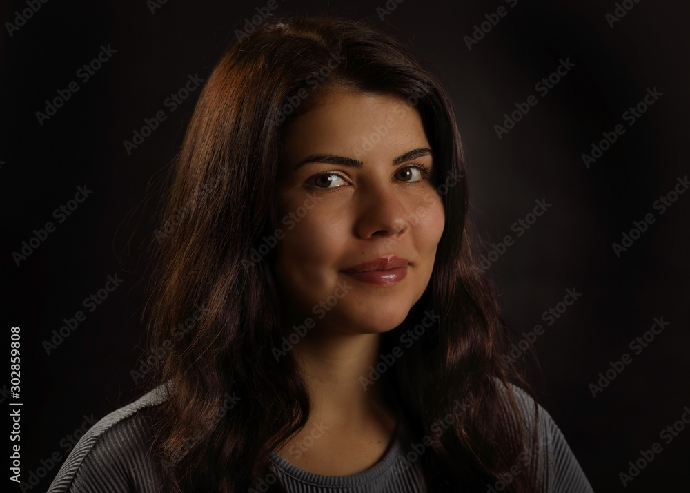 Portrait of a beautiful brunette girl with a smile on her face Portrait of a beautiful brunette girl with a smile on her face