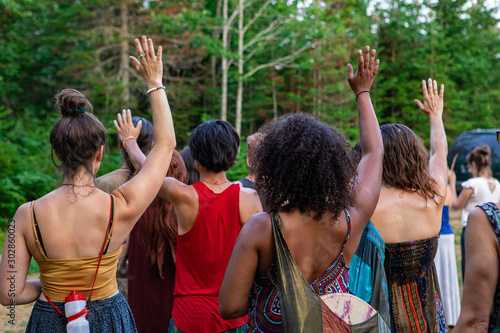 Cuadro en lienzo a diverse group of multi-generational women viewed from behind, arms raised in a