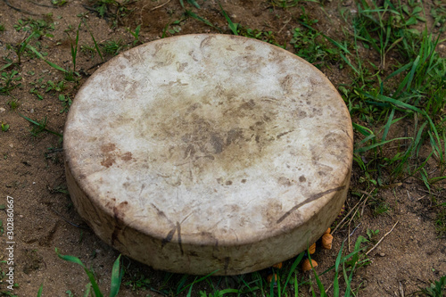 Close Up of Sacred drum on the ground outdoors in the woodland, spiritual shamanic traditional native music instrument