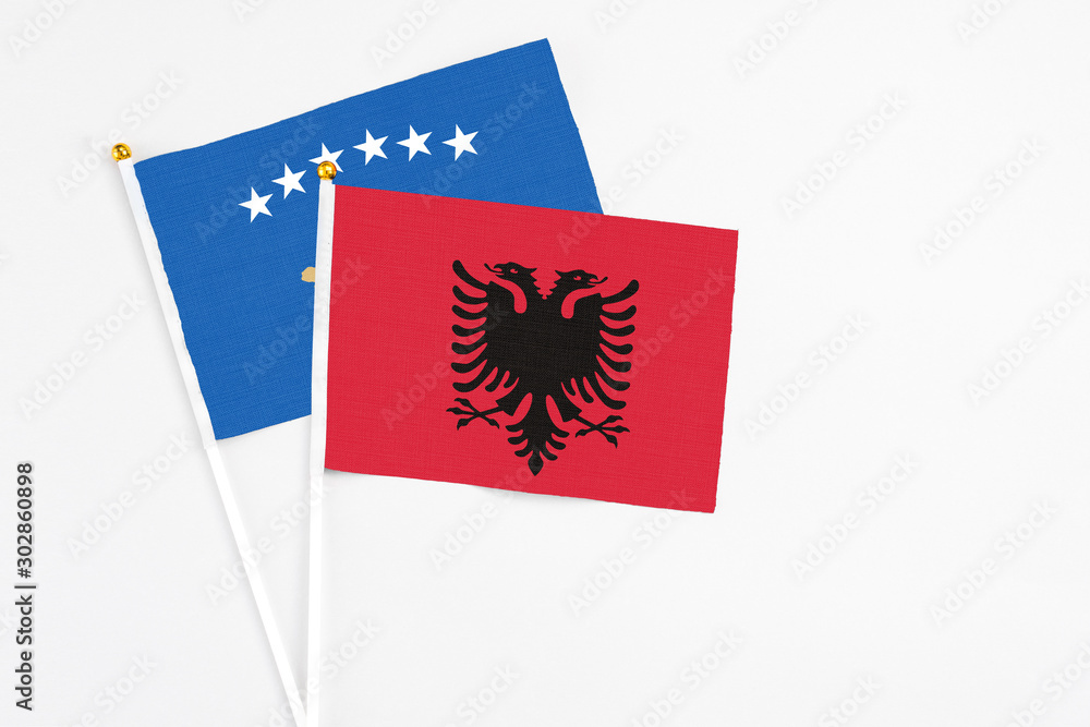 Albania and Kosovo stick flags on white background. High quality fabric, miniature national flag. Peaceful global concept.White floor for copy space. Albania and Kosovo stick flags on white background. High quality fabric, miniature national flag. Peaceful global concept.White floor for copy space.