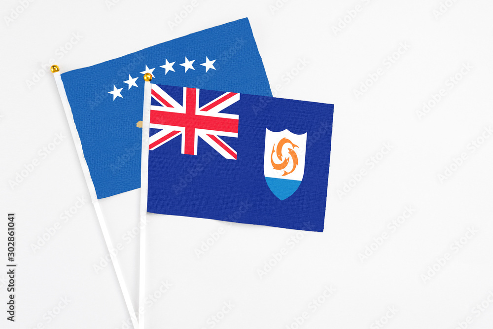 Fototapeta premium Anguilla and Kosovo stick flags on white background. High quality fabric, miniature national flag. Peaceful global concept.White floor for copy space.