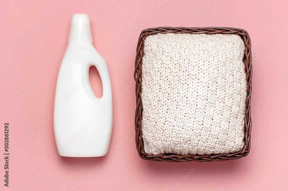 Eco washing concept. White plastic packaging of laundry detergent, liquid  powder, washing conditioner, knitted sweater, rattan wicker basket on pink  background. Flat lay top view. Bio organic product Stock Photo | Adobe