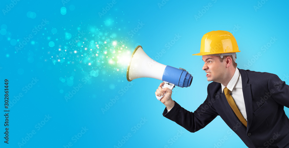 Young architect constructor yelling with megaphone and sparkling sounds Young architect constructor yelling with megaphone and sparkling sounds
