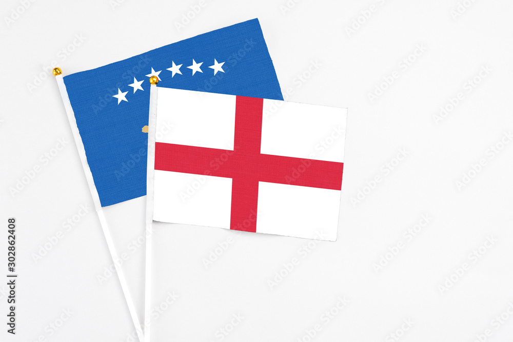England and Kosovo stick flags on white background. High quality fabric, miniature national flag. Peaceful global concept.White floor for copy space.