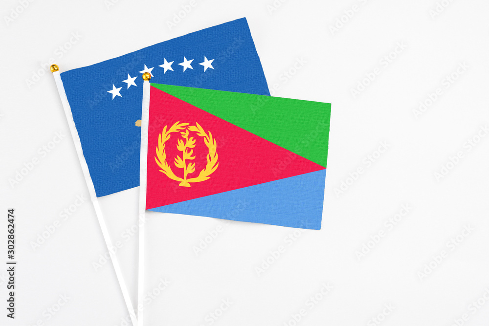 Obraz premium Eritrea and Kosovo stick flags on white background. High quality fabric, miniature national flag. Peaceful global concept.White floor for copy space.