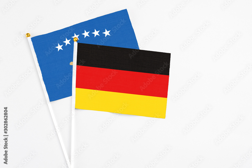 Germany and Kosovo stick flags on white background. High quality fabric, miniature national flag. Peaceful global concept.White floor for copy space. Germany and Kosovo stick flags on white background. High quality fabric, miniature national flag. Peaceful global concept.White floor for copy space.