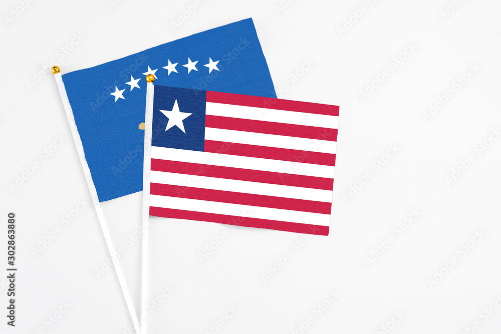 Liberia and Kosovo stick flags on white background. High quality fabric, miniature national flag. Peaceful global concept.White floor for copy space. Liberia and Kosovo stick flags on white background. High quality fabric, miniature national flag. Peaceful global concept.White floor for copy space.