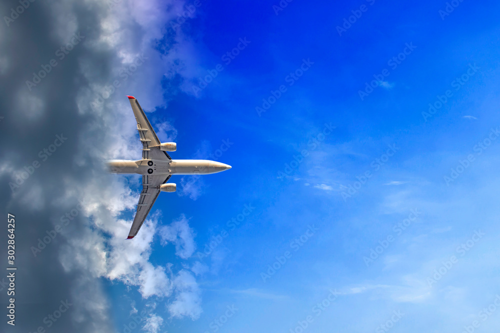 Fototapeta premium The plane comes out of the clouds. Each of the planes is entering the cloud in its own way. Writing area