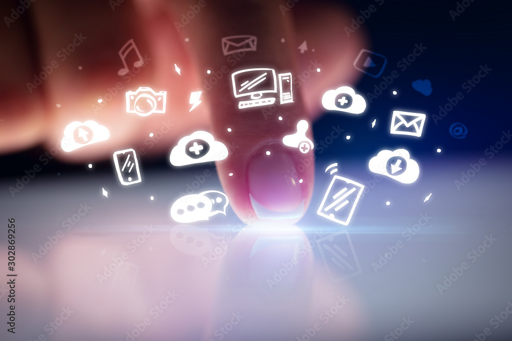 Finger touching tablet with white drawn application icons and dark background Finger touching tablet with white drawn application icons and dark background