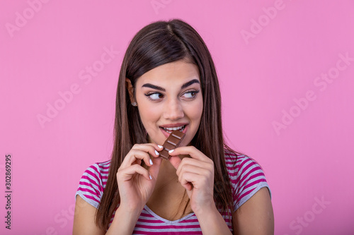 Photography Happy young beautiful lady eating chocolate and smiling