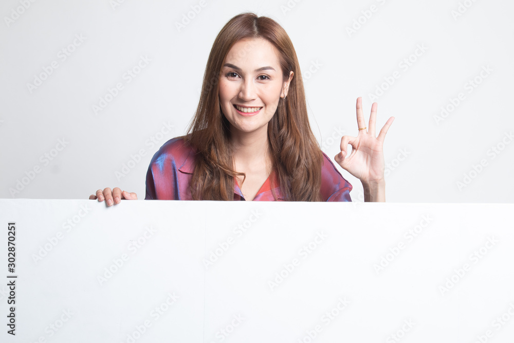 Fototapeta premium Young Asian woman show OK with blank sign.