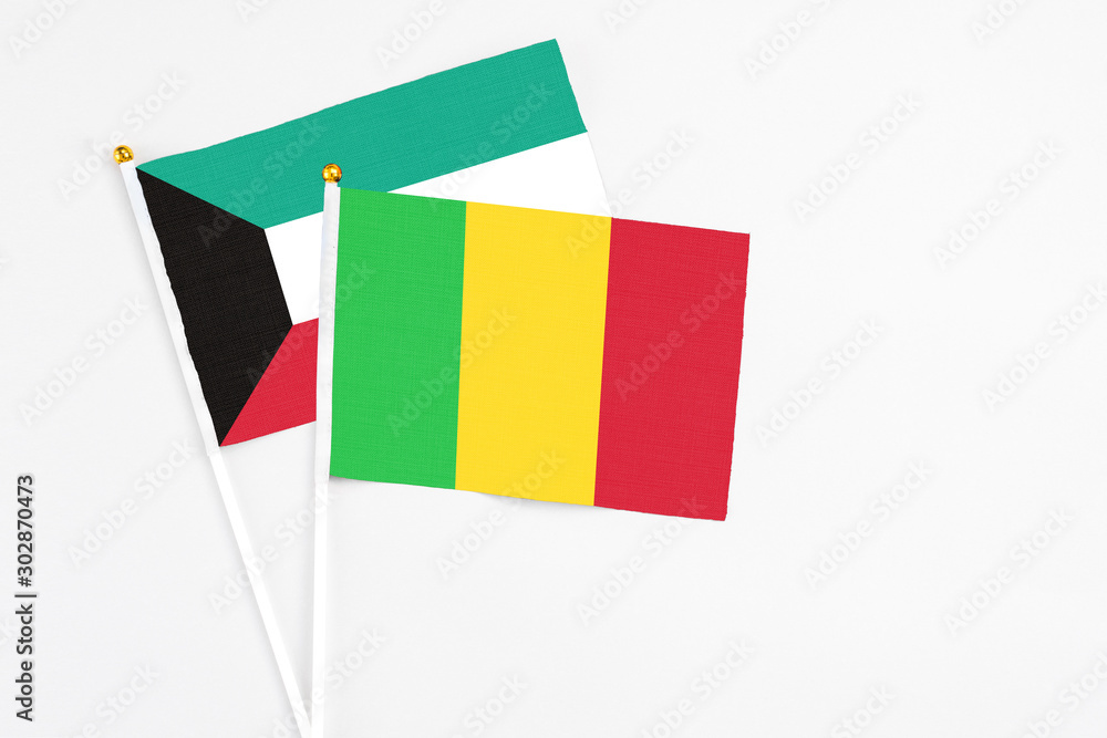 Mali and Kuwait stick flags on white background. High quality fabric, miniature national flag. Peaceful global concept.White floor for copy space. Mali and Kuwait stick flags on white background. High quality fabric, miniature national flag. Peaceful global concept.White floor for copy space.