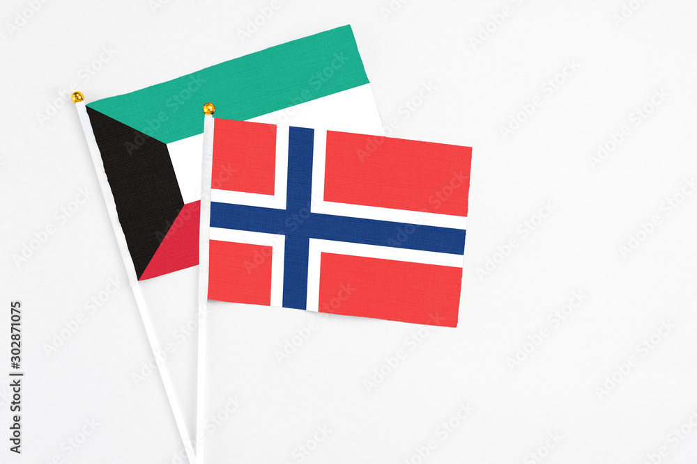 Norway and Kuwait stick flags on white background. High quality fabric, miniature national flag. Peaceful global concept.White floor for copy space.
