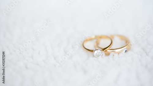 Diamond wedding rings on white soft wool
