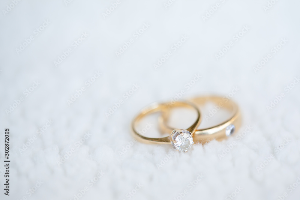 Diamond wedding rings on white soft wool Diamond wedding rings on white soft wool