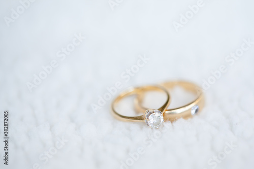 Diamond wedding rings on white soft wool