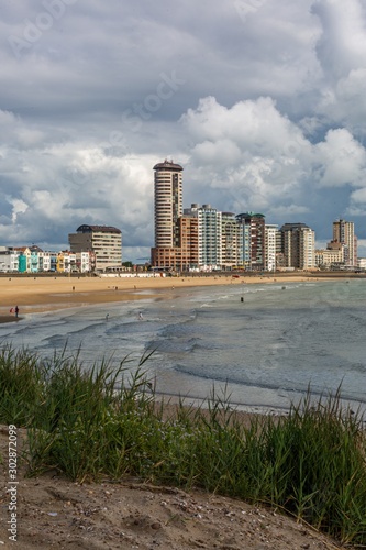 Vertical shot of the calm ocean waves moving towards the shore in Vlissingen, Zeeland, Netherlands photo