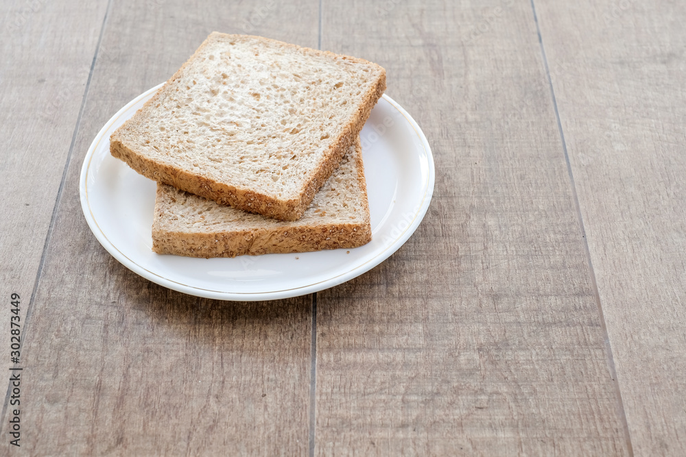 Fresh and nutritious whole wheat bread on wooden background Fresh and nutritious whole wheat bread on wooden background