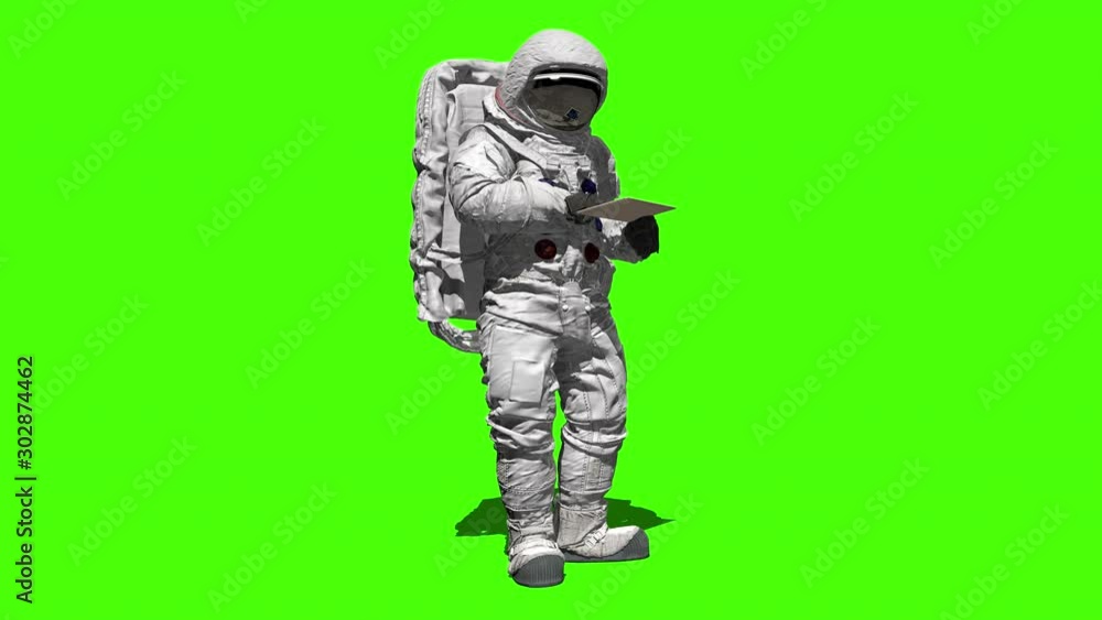 Astronaut on the moon typing on a laptop with a green screen. Astronaut on the moon typing on a laptop with a green screen.