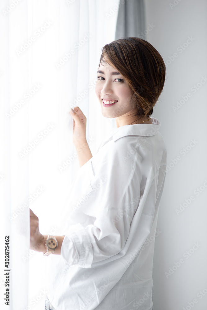 Beautiful woman with white curtain with natural light. Beautiful woman with white curtain with natural light.
