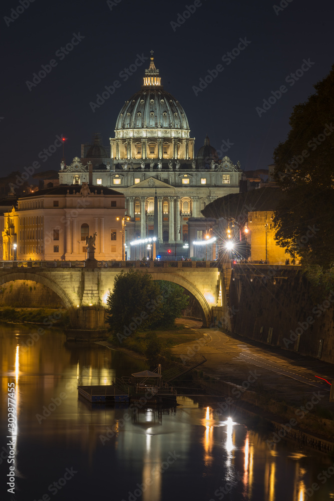 Fototapeta premium Dusk at the Vatican City. St. Peter's basilica in Rome, Vatican, the dome at sunset with reflection. Night view at St. Peter's cathedral in Rome, Italy. Scenic background. Popular travel destination.