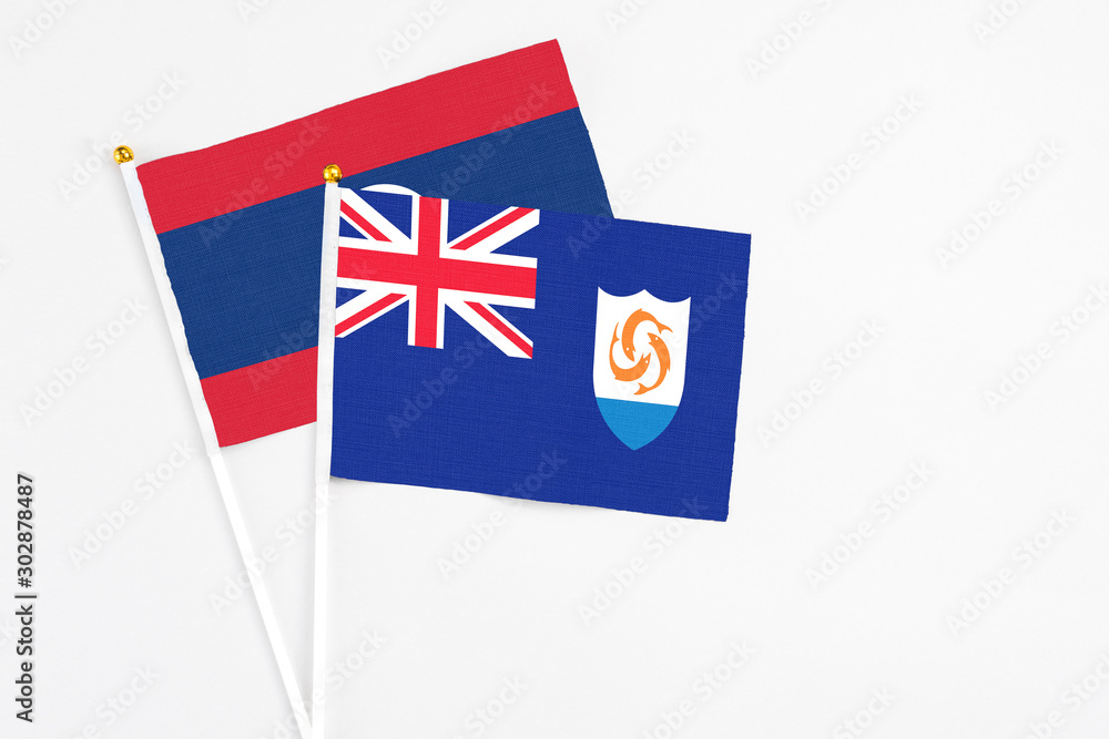 Anguilla and Laos stick flags on white background. High quality fabric, miniature national flag. Peaceful global concept.White floor for copy space. Anguilla and Laos stick flags on white background. High quality fabric, miniature national flag. Peaceful global concept.White floor for copy space.