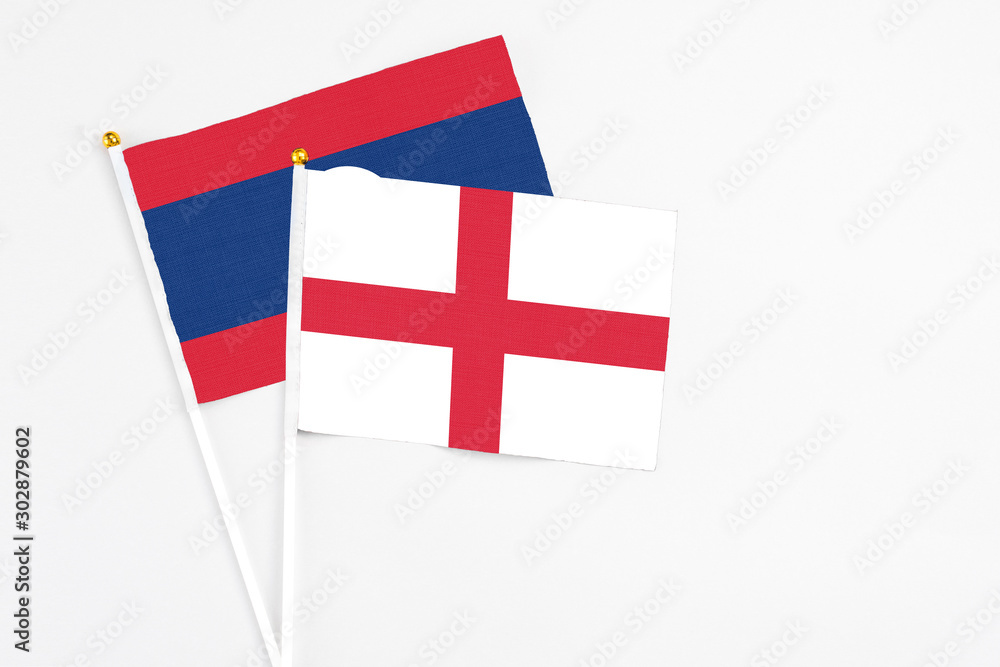 England and Laos stick flags on white background. High quality fabric, miniature national flag. Peaceful global concept.White floor for copy space.