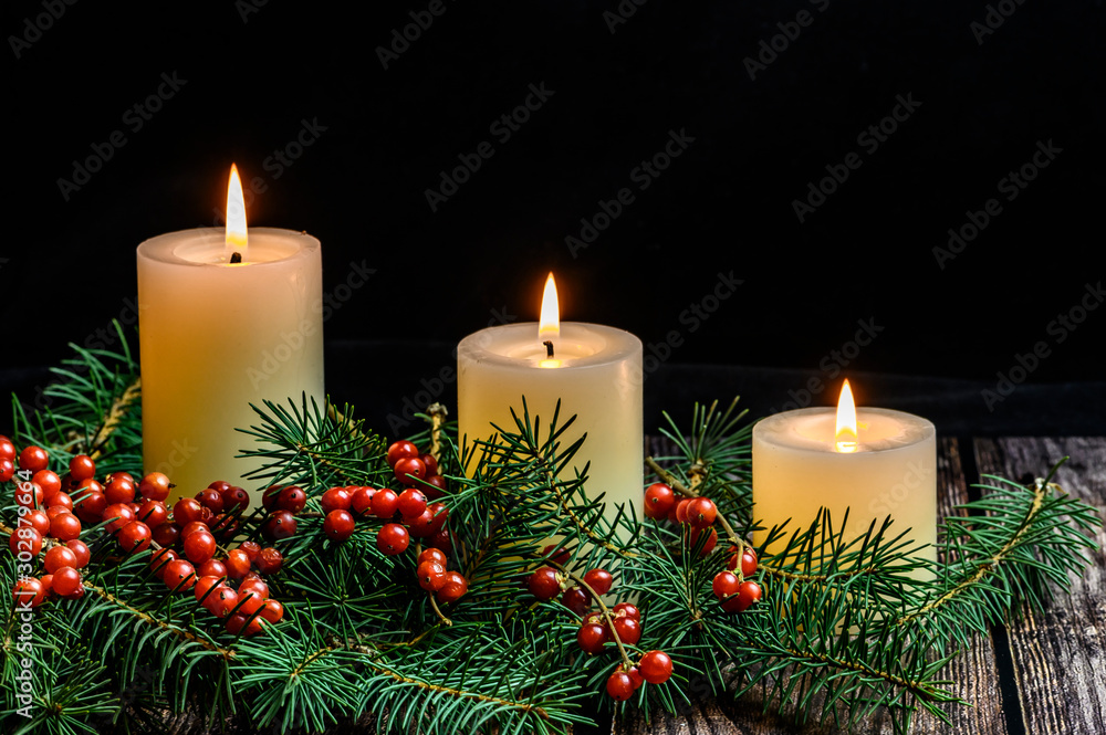 Christmas candle on black background Christmas candle on black background