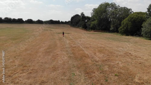 Wallpaper Mural Boy Walking In Dry Summer Grass Meadow Field Aerial View Torontodigital.ca