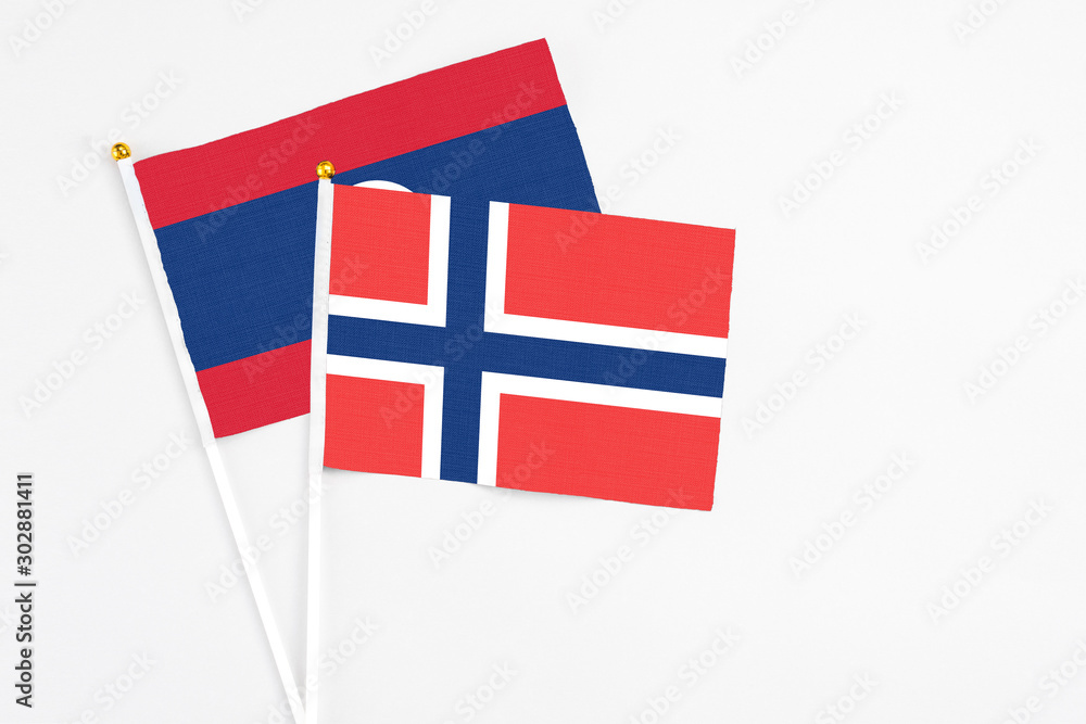 Norway and Laos stick flags on white background. High quality fabric, miniature national flag. Peaceful global concept.White floor for copy space.