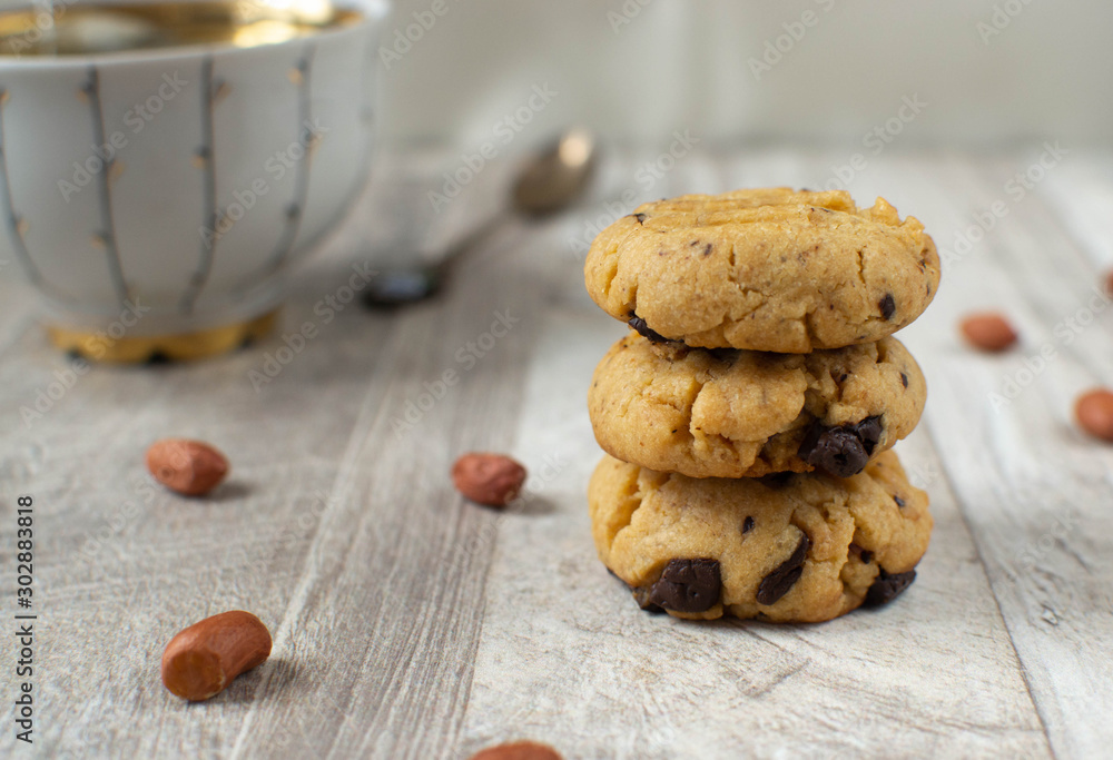 Chocolate chip cookies and cup of tea on wooden table freshly baked.  
