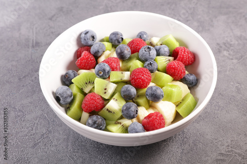 bowl of fresh fruit salad with berry  banana and kiwi- healthy eating