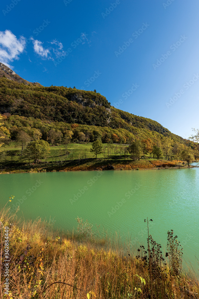 Lago di Tenno in autumn, small beautiful lake in Italian Alps. Trento province, Trentino-Alto Adige, Italy, Europe