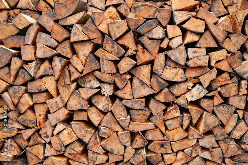 Stack of firewood. A lot of firewood stacked wall. Chopped wood. Stack of firewood. A lot of firewood stacked wall. Chopped wood.