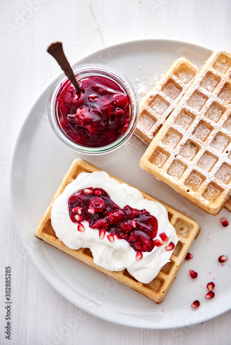  waffles with powdered sugar, whipped cream and fruit gel