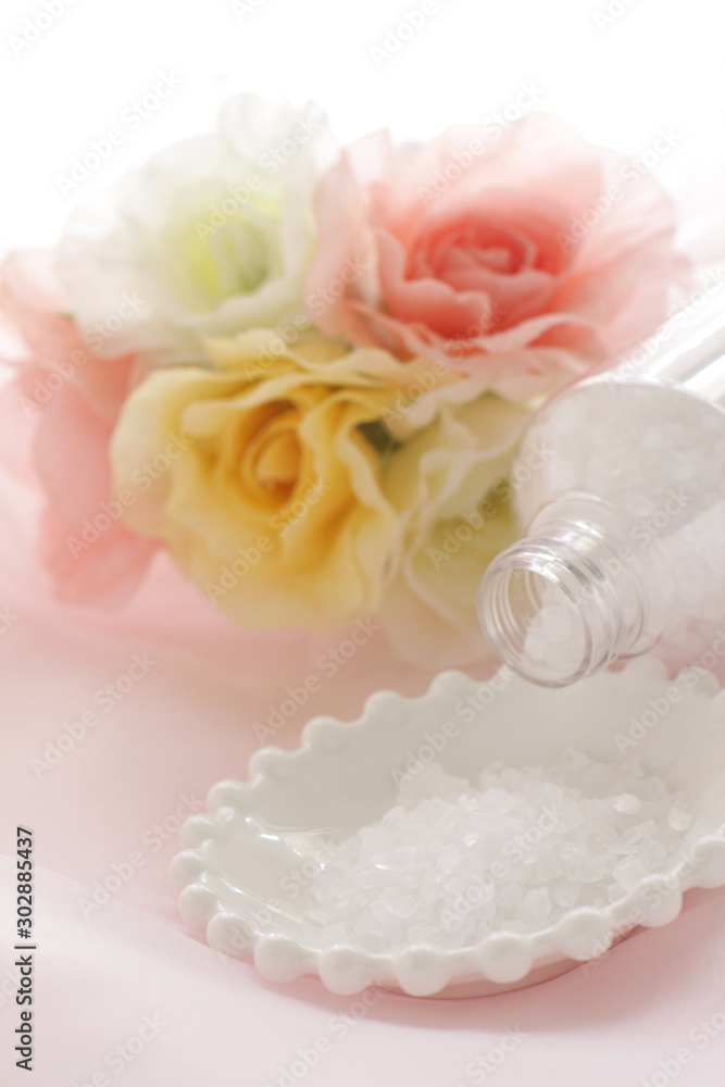 Rock salt on white plate with flower for beauty image Rock salt on white plate with flower for beauty image
