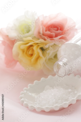 Rock salt on white plate with flower for beauty image