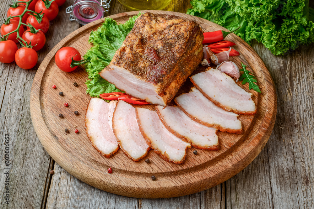 Slices of bacon on the wooden background. Slices of bacon on the wooden background.