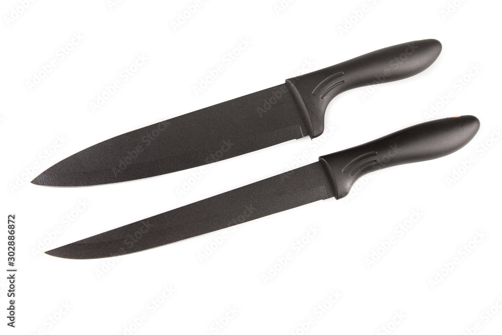 Sliced black grooved knife isolated on a white background Dark blade rubber grip Kitchen tool cook Sliced black grooved knife isolated on a white background Dark blade rubber grip Kitchen tool cook