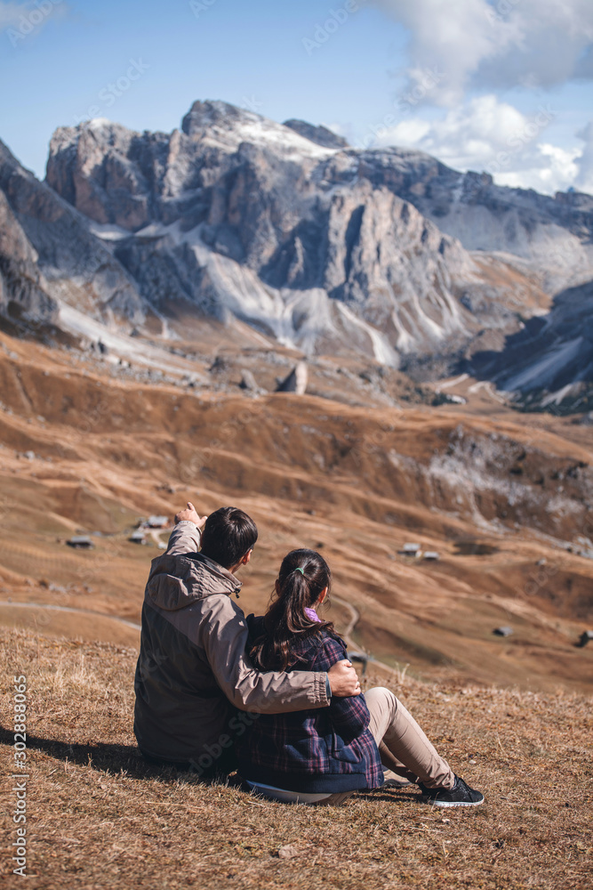 Fototapeta premium couple in love sitting in the Dolomites near Mount Sceda