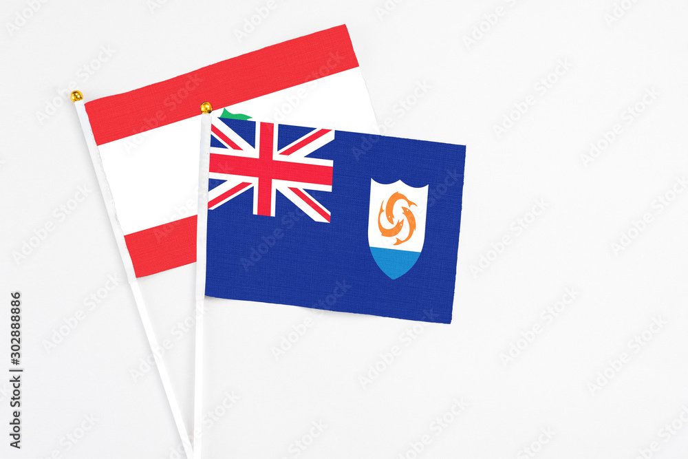 Fototapeta premium Anguilla and Lebanon stick flags on white background. High quality fabric, miniature national flag. Peaceful global concept.White floor for copy space.