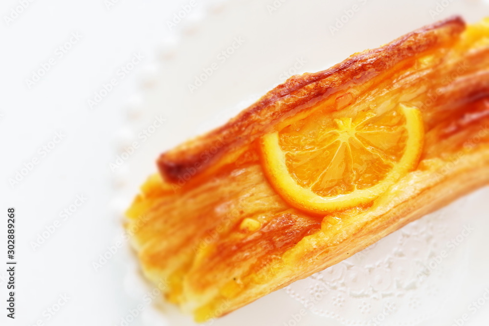 Orange pastry bread on dish Orange pastry bread on dish