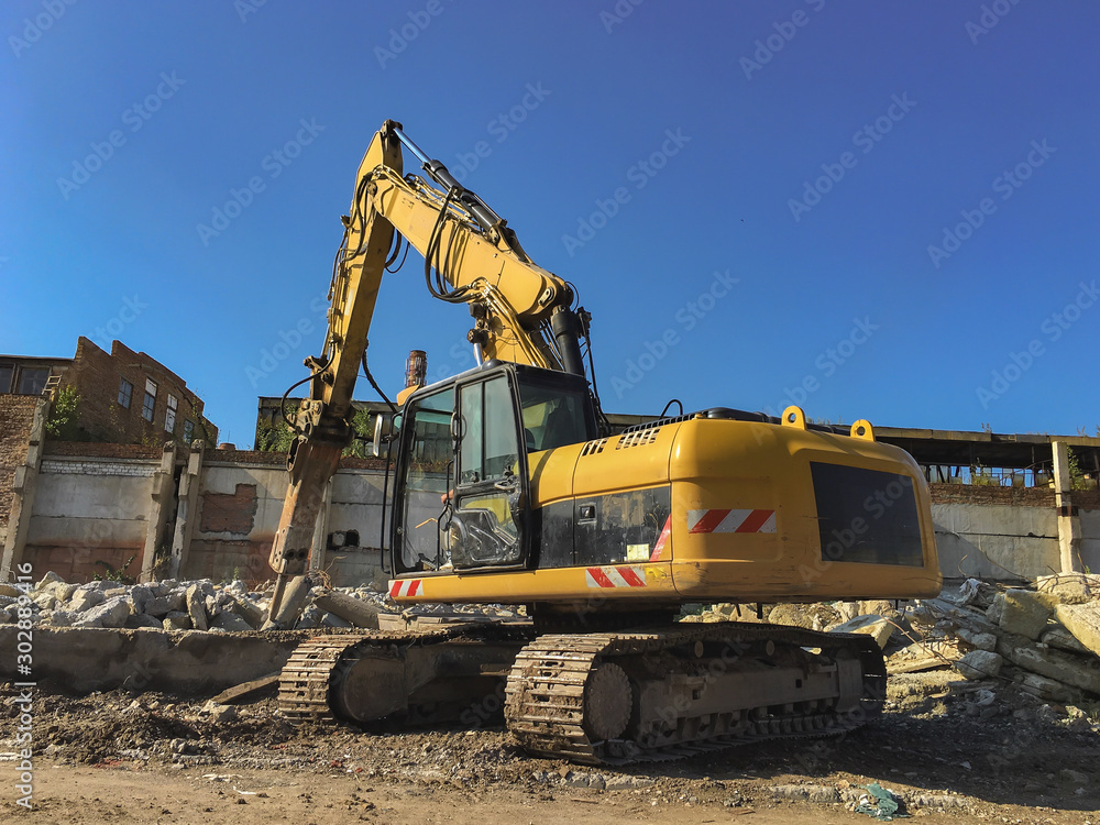 Demolition house using excavator in city. Rebuilding process. Remove equipment. Demolition house using excavator in city. Rebuilding process. Remove equipment.