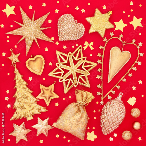 Christmas tree bauble decorations in gold on red background. Traditional greetings card for the festive season.