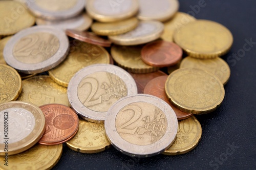 Euro coins on black background.